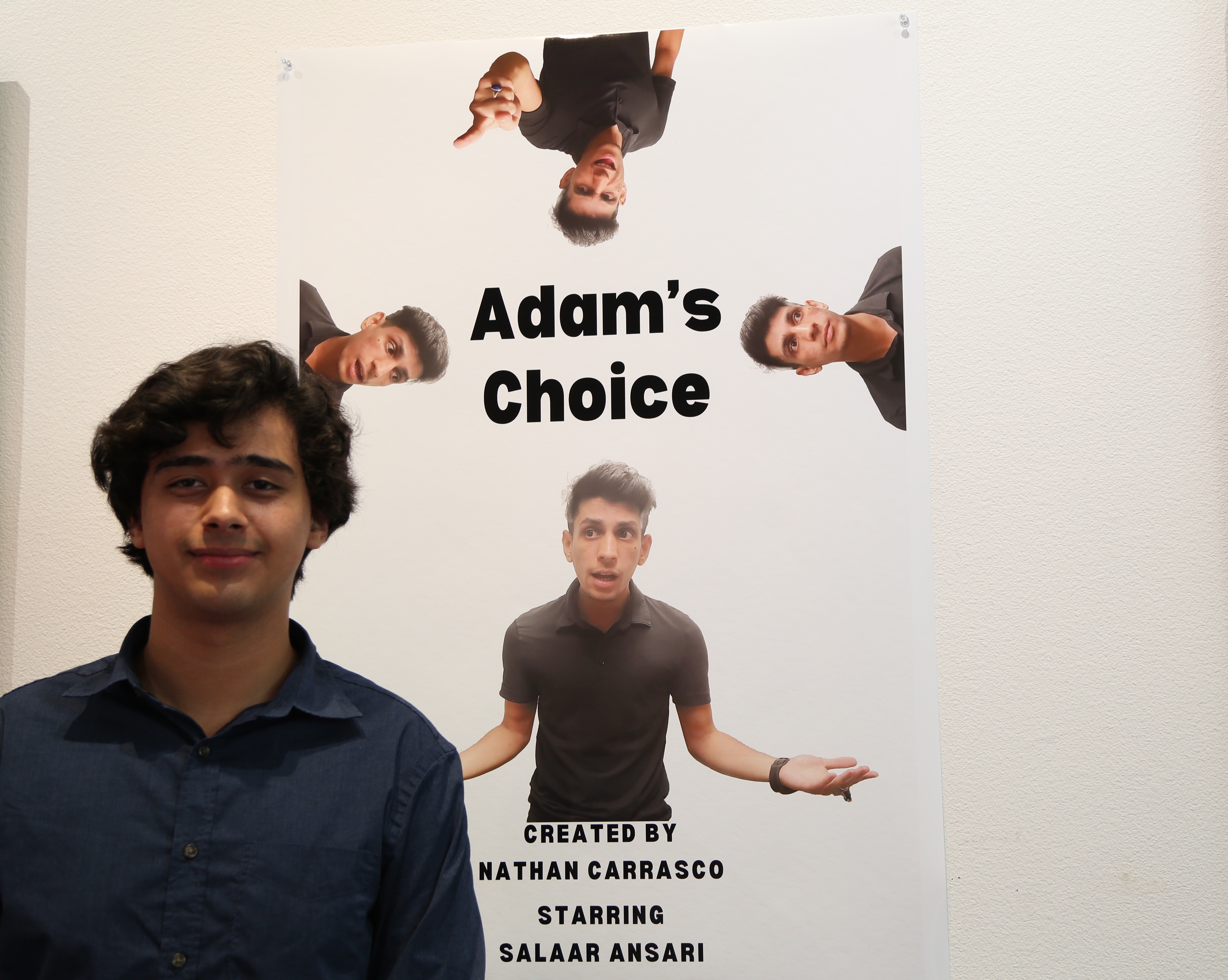 Nathan Carrasco stands next to a poster for his comedy Adam’s Choice. | Brandy Vargas/Whittier College