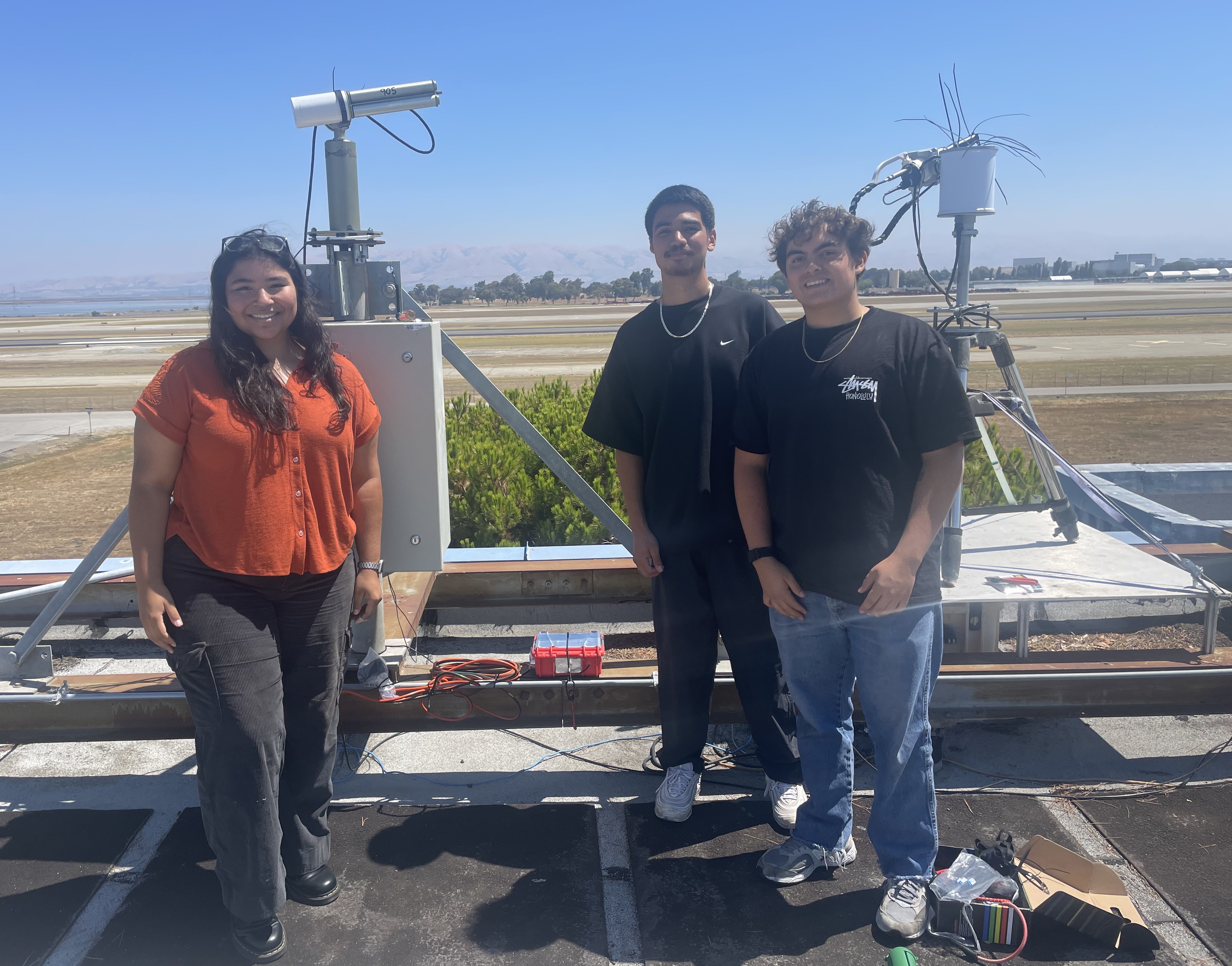 Isabel Barriento ’25, Juan Alvarez ’27, and Dylan Zeledon ’27 pose next to scientific equipment. | Whittier College