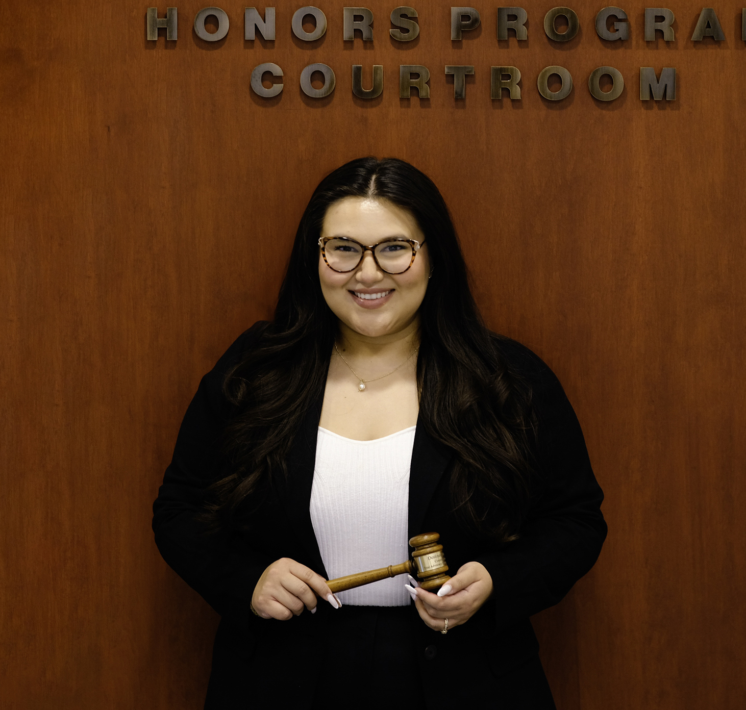 Destinee at courtroom holding gavel