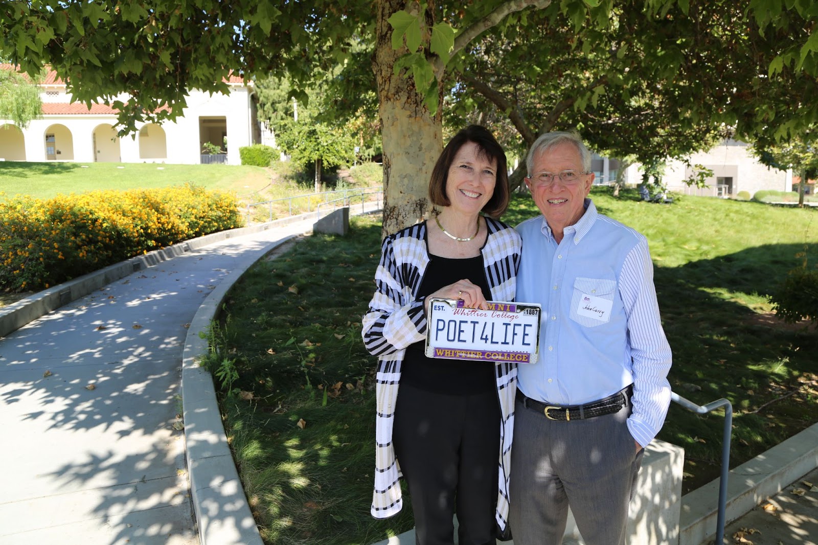 President Kristine E. Dillon ’73,  left, holds a Poet4Life license plate with her husband John Curry during the Poet4Life tour. The tour was an opportunity to for people to meet the new leadership
