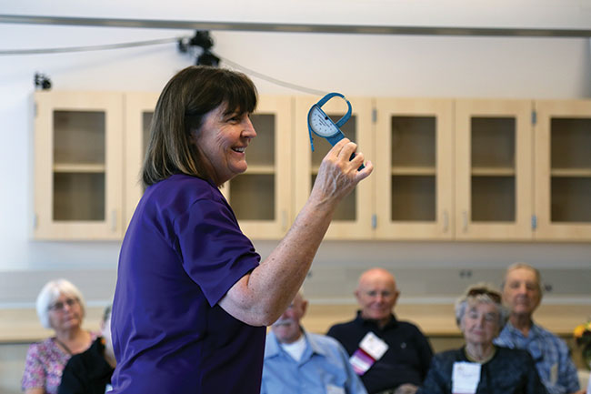 Trish Van Oosbree holds up a tool in the movement lab.