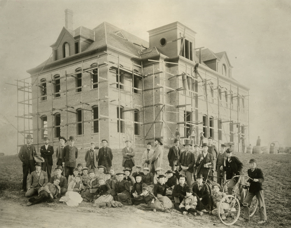 Academy students and faculty in front of Founders Hall during construction in 1894