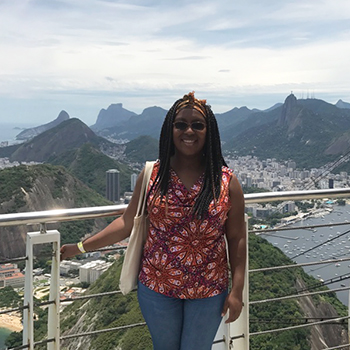 Anthropology major Esther Hills at a high point in Brazil, with mountains and a city behind her.