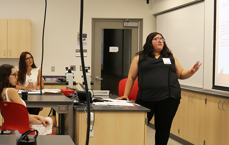 Daniela Vega presents research in a classroom.