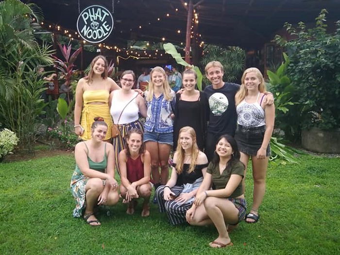 A group photo outside a Costa Rican restaurant.