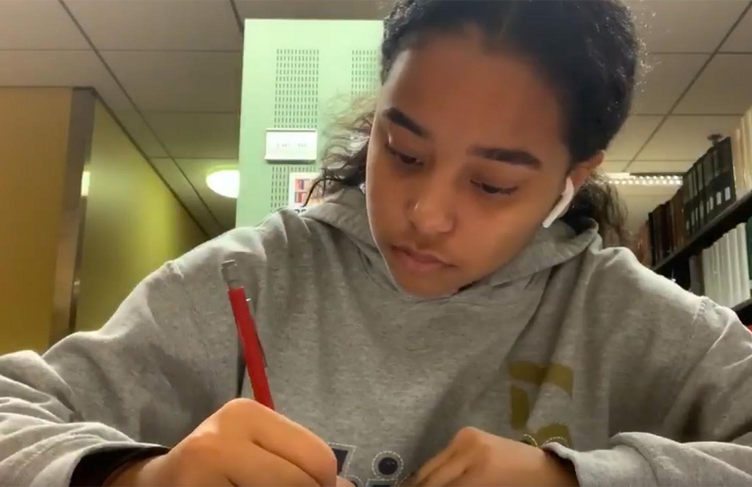 Nicole studying in the library