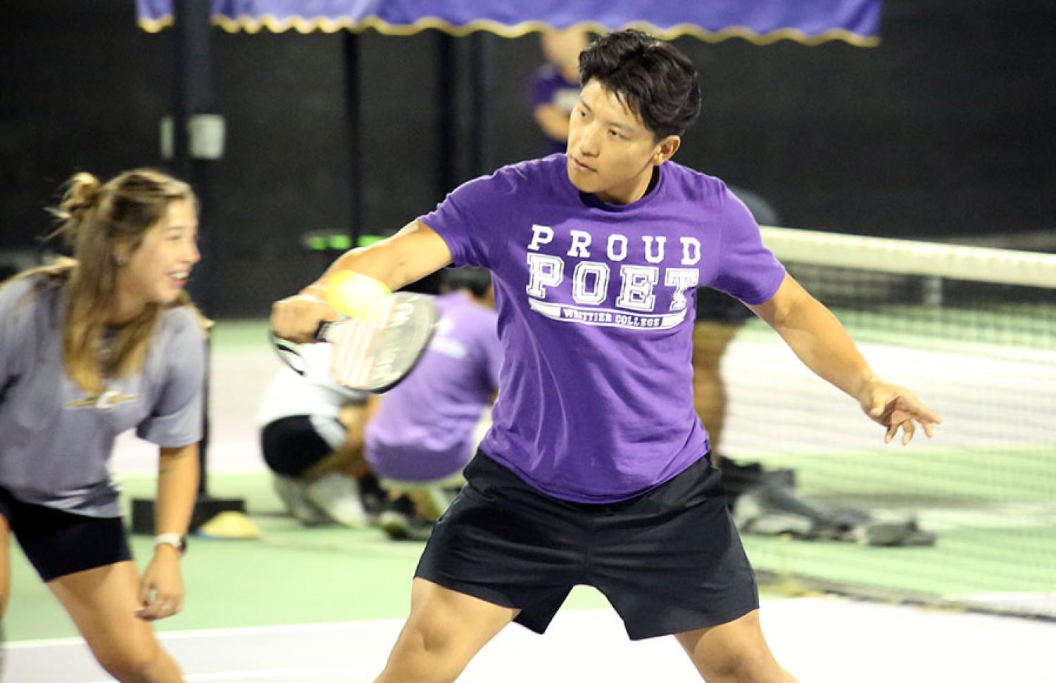 Two people playing pickleball