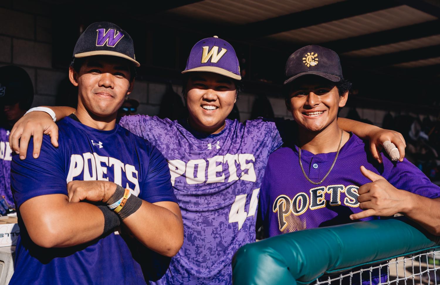 Three baseball players hugging