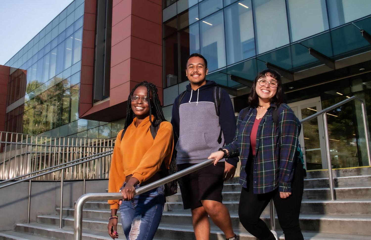 Three students outside science building