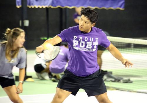 Two people playing pickleball