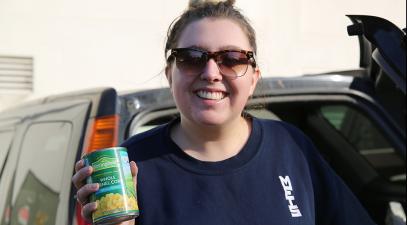 Student holding can of food.