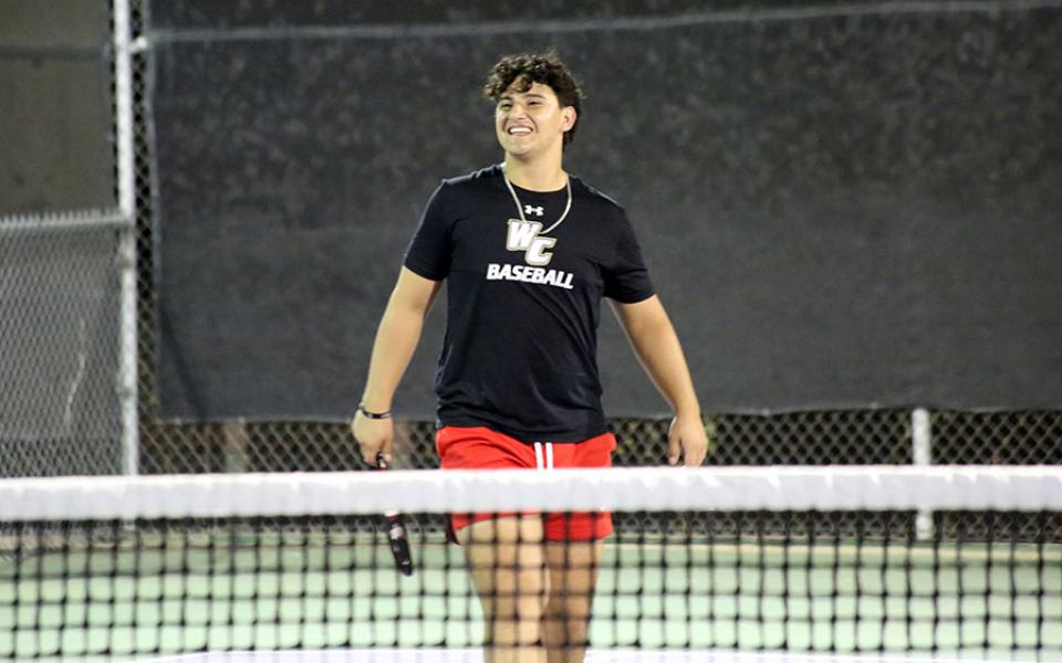 Student on tennis court